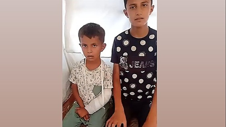 13-year-old Zain in Gaza and Karim, displaced brothers in Gaza 13-year-old Zain in Gaza sits beside his younger brother Karim. Karim’s arm is bandaged after surgery, and both boys look solemn inside a tent.